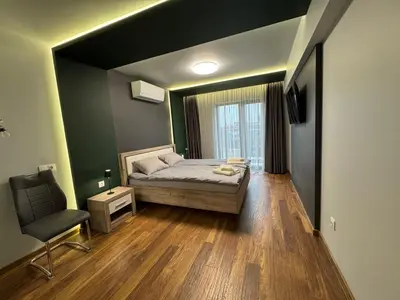 a bedroom with a bed and a chair in it at Dream Home A21 in Sofia