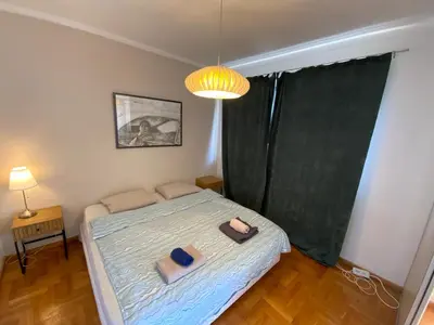 a bedroom with a bed with two towels on it at Zaimov Penthouse with great view in Sofia