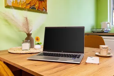 a laptop computer sitting on top of a wooden table at Sunflower Studio next to Kolodrum Plovdiv in Plovdiv