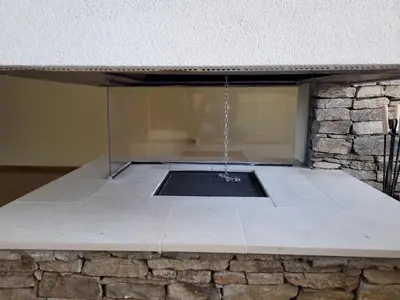 a patio with a window in a stone wall at Pirin Golf Villa Sokol in Bansko