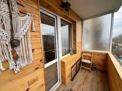 a porch of a wooden cabin with large windows at Lovely cozy vintage apartment in Kyustendil
