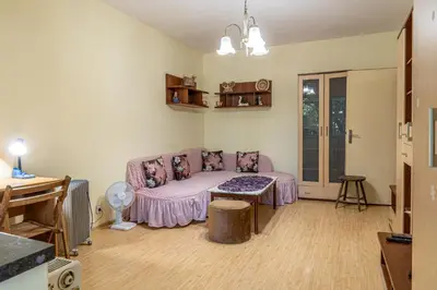 a living room with a couch and a table at The Lindens 1 Bedroom Cozy Apartment plus Free Parking!!! in Sofia