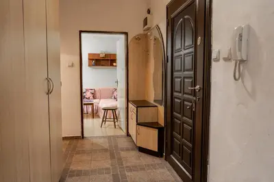 a hallway with a door and a room with a table at The Lindens 1 Bedroom Cozy Apartment plus Free Parking!!! in Sofia