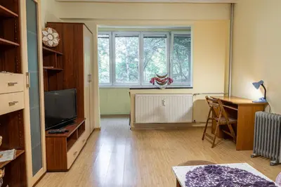 a living room with a tv and a desk and a window at The Lindens 1 Bedroom Cozy Apartment plus Free Parking!!! in Sofia