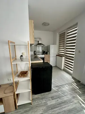 a kitchen with a black island in a room at TVS Apartment-City centre in Plovdiv