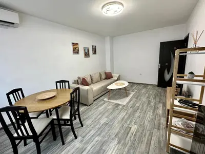 a living room with a table and a couch at TVS Apartment-City centre in Plovdiv