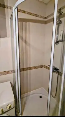 a glass shower in a bathroom with a toilet at Apartment - Studio Cucetno in Sandanski