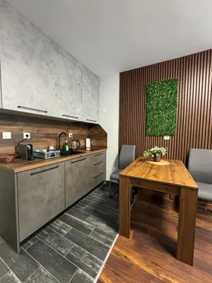 a kitchen with a wooden table and a counter at Dream Home A3 in Sofia