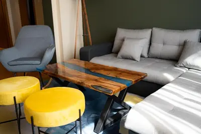 a living room with a couch and a table and stools at 1 Minute Walk to Main Street Vitoshka, NDK, Free Parking, 2 BDR in Sofia