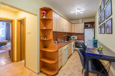a kitchen with wooden cabinets and a counter top at 1 Minute Walk to Main Street Vitoshka, NDK, Free Parking, 2 BDR in Sofia