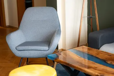 a living room with a chair and a coffee table at 1 Minute Walk to Main Street Vitoshka, NDK, Free Parking, 2 BDR in Sofia