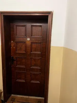 a wooden door in a room with at Spacious artsy apartment in Sofia