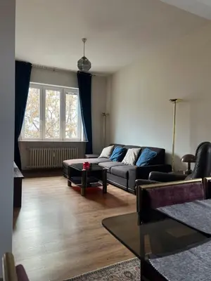 a living room with a couch and a table at Spacious artsy apartment in Sofia