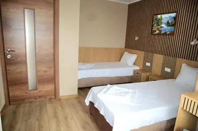 a hotel room with two beds and a door at Nara in Pchelin