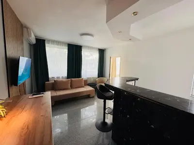 a living room with a couch and a bar at Green Accent Apartment in Sofia