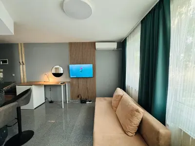 a living room with a couch and a table at Green Accent Apartment in Sofia