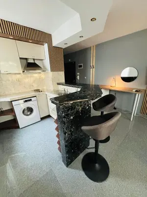a kitchen with a counter and a stool in a room at Green Accent Apartment in Sofia