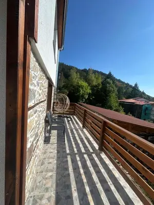 a balcony of a house with a wooden fence at Mountain Whisper Guesthouse in Smolyan