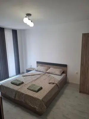 a bedroom with a bed with two pillows on it at Апартамент Актив Спорт Гранд in Pazardzhik