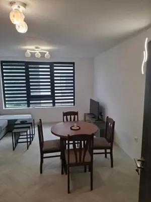 a dining room with a table and chairs at Апартамент Актив Спорт Гранд in Pazardzhik