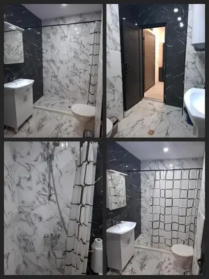 a bathroom with two sinks and a mirror at Апартамент Актив Спорт Гранд in Pazardzhik