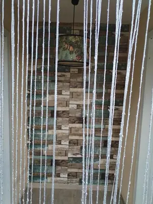 a wall made out of wood and white stringaments at Вила 