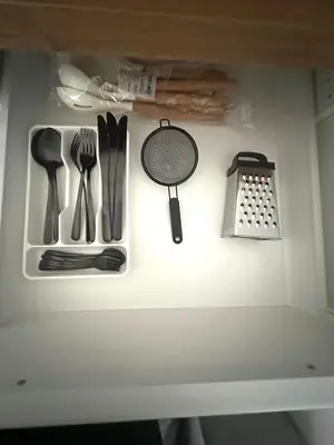 a drawer filled with kitchen utensils on a shelf at Rose studio - Bulgaria mall, Brand New, Ground floor, Family-friendly, Baby cot&chair, Mountain view, Self check-in, Free Public parking and Paid underground in the mall in Sofia