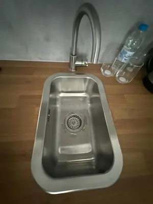a stainless steel sink with a faucet in a kitchen at Rose studio - Bulgaria mall, Brand New, Ground floor, Family-friendly, Baby cot&chair, Mountain view, Self check-in, Free Public parking and Paid underground in the mall in Sofia