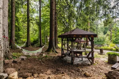 a gazebo in the middle of a forest at Хижа Кукер - Арт Хижа за Вдъхновение и Отдих in Sofia