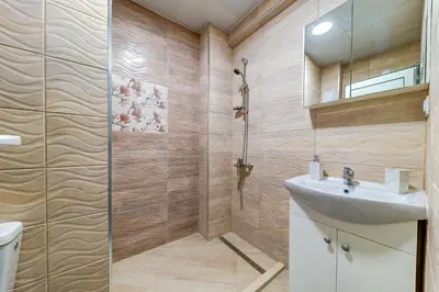 a bathroom with a shower and a sink at Bright retreat with Balcony & Mountain Views by Flat Manаger in Smolyan