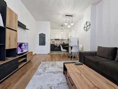 a living room with a couch and a table at SUPERsonicondo in Plovdiv