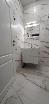 a white bathroom with a sink and a white door at SUPERsonicondo in Plovdiv