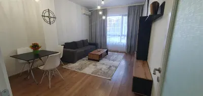 a living room with a couch and a table at SUPERsonicondo in Plovdiv
