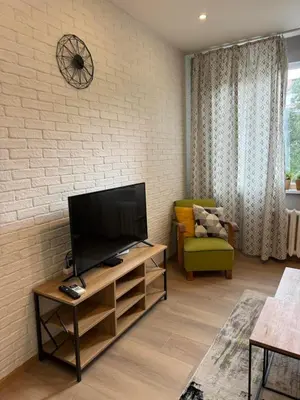 a living room with a flat screen tv and a couch at Happy Day in Sofia