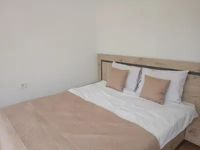 a large bed with white sheets and pillows at Apartment B35, complex Sokolitsite in Pamporovo