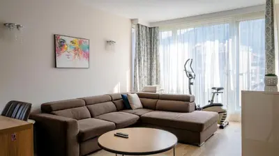 a living room with a couch and a table at Modern & Spacious Stay by Flat Mаnager in Sofia