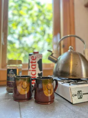 two coffee mugs sitting on a counter next to a stove at Camping Kromidovo in Kromidovo