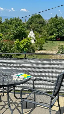 a table and a chair sitting on a patio at Camping Kromidovo in Kromidovo