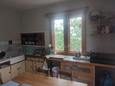 a kitchen with a table and a large window at Camping Kromidovo in Kromidovo