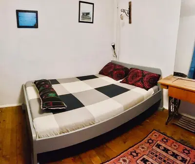 a bed in a room with a checkeredkered at Camping Kromidovo in Kromidovo