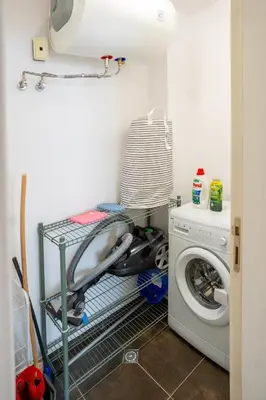 a laundry room with a washer and a washing machine at Mountain View Sky Apartment Ori 4 in Sofia