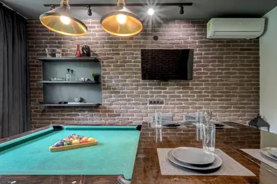 a pool table with a bowl of fruit on top of it at Sophisticated 2BDRM 2BATH and Billiard in Sofia