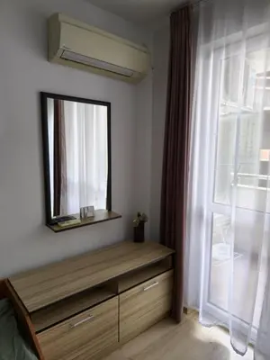 a bedroom with a dresser with a mirror and a window at Studio Kasandra in Hisarya