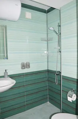 a bathroom with a glass shower and a sink at Cozy apartment for overnight stays Hristo Smirnenski in Plovdiv