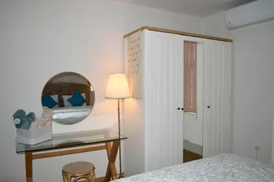 a bedroom with a mirror and a table with a bed at Cozy apartment for overnight stays Hristo Smirnenski in Plovdiv