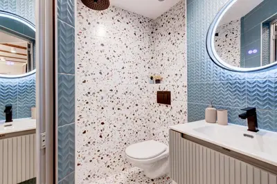 a bathroom with a toilet and a sink and a mirror at City Gem 1BDRM 200m Sofia Statue in Sofia