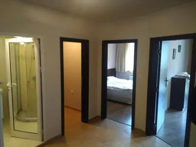 a room with two doors and a bedroom with a bed at Apart Hotel Forest Nook 3 Pamporovo in Pamporovo