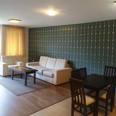 a living room with a couch and a table at Apart Hotel Forest Nook 3 Pamporovo in Pamporovo