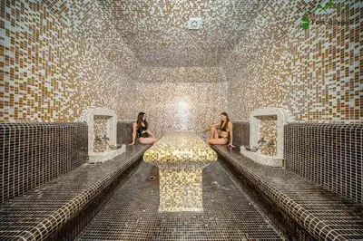 two women sitting in a room with a table at Apart Hotel Forest Nook 3 Pamporovo in Pamporovo