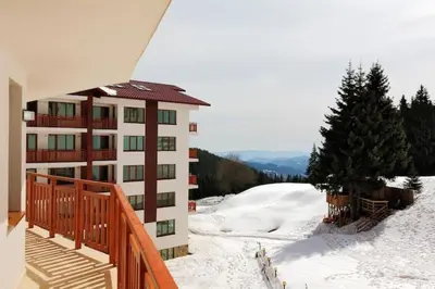 a balcony of a building in the snow at Apart Hotel Forest Nook 3 Pamporovo in Pamporovo